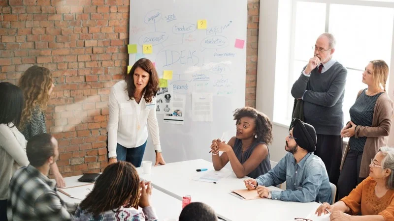 Colleagues planning together around a table in an office